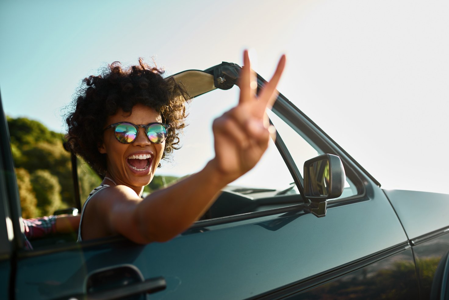 Young woman enjoying car road trip